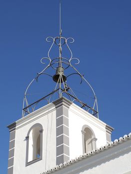White bell tower church in Albufeira at the Algarve coast of Portugal