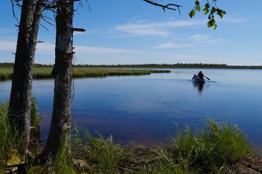 Fishermen on the boat approach to the shore. Fishermen in Ugra.