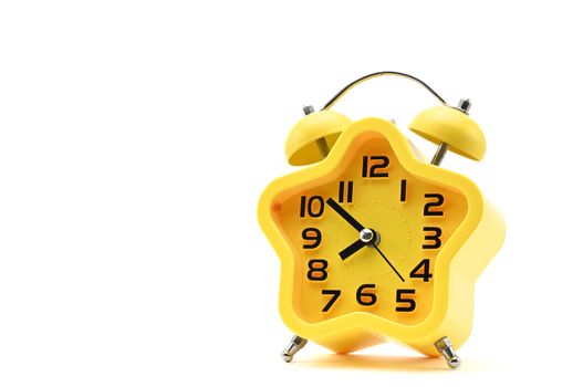 Yellow watch with five petals. Alarm clock on a white background