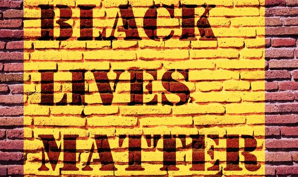 Black Lives Matter slogan protestors anti Black racism african American yellow stencil pattern brick wall texture background