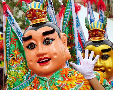 KAOHSIUNG, TAIWAN -- AUGUST 15, 2015: Two dancers in modernized costumes of the Chinese Third Prince tradition pose at a local temple carnival.