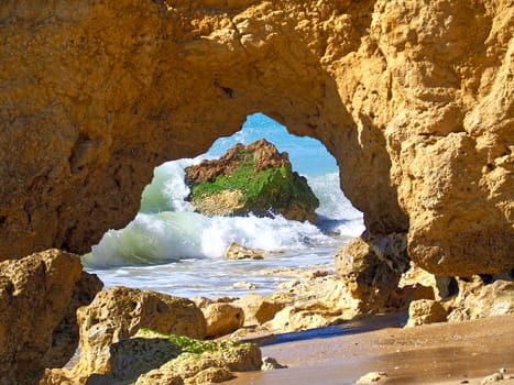 Red cliffs in blue sea at paradise beach Praia da Oura at the Algarve coast of Portugal