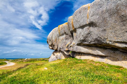 Ocean coast in Meneham village with granite rocks and boats, Kerlouan, Finistere, Brittany (Bretagne), France