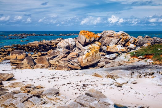 Ocean coast in Meneham village with granite rocks and boats, Kerlouan, Finistere, Brittany (Bretagne), France