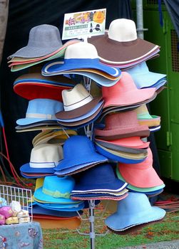 KAOHSIUNG, TAIWAN -- JUNE 14, 2015: An outdoor vendor sells fashionable hats made out of paper.
