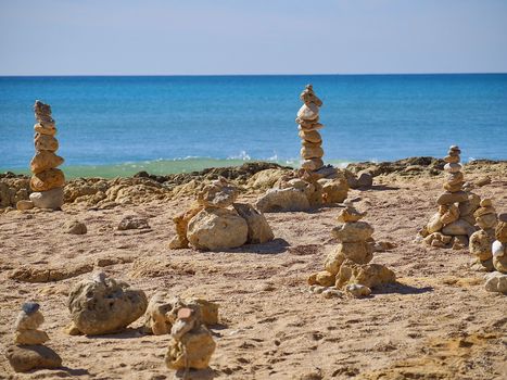 Stack of stones for balance and harmony in front of blue ocean