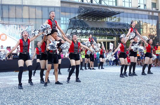 KAOHSIUNG, TAIWAN -- JUNE 17, 2015: Students from the Shu-Te High School perform a free outdoor dance for the start of the Dragon Boat Festival.