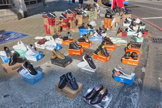 KAOHSIUNG, TAIWAN -- DECEMBER 1, 2019: A street vendor sells new shoes on the sidewalk on a street corner.
