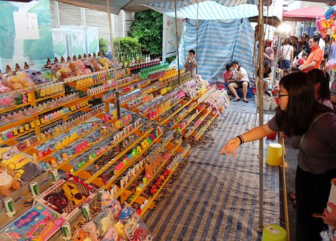 KAOHSIUNG, TAIWAN -- MAY 30, 2017: During the Dragon Boat Festival people play a skill game of throwing rings over small objects to win a prize.