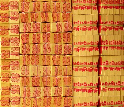 KAOHSIUNG, TAIWAN -- MARCH 16, 2014: A large stack of joss paper is prepared for burnt offerings at a local religious ceremony.