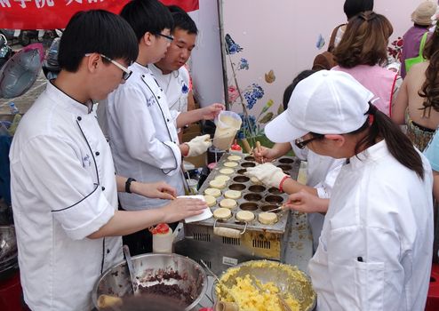 KAOHSIUNG, TAIWAN -- DECEMBER 8, 2018: Cooking school students make red bean cakes, or Imagawayaki, as the Japanese call it, a popular sweet food in Taiwan.