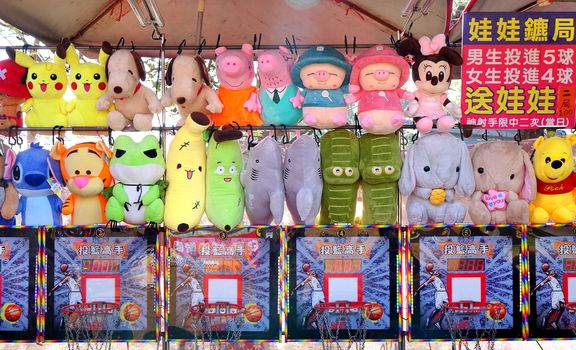 KAOHSIUNG, TAIWAN -- JANUARY 5, 2019: An outdoor skill game stall offers television animation characters merchandise for prizes to those who win.
