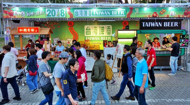 KAOHSIUNG, TAIWAN -- FEBRUARY 19, 2018: A large stall sells beer and snack foods at the 2018 Lantern Festival that welcomes the Year of the Dog.