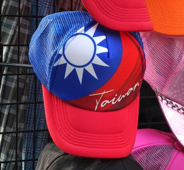 KAOHSIUNG, TAIWAN -- DECEMBER 14, 2019: A street vendor sells caps imprinted with the flag of Taiwan.
