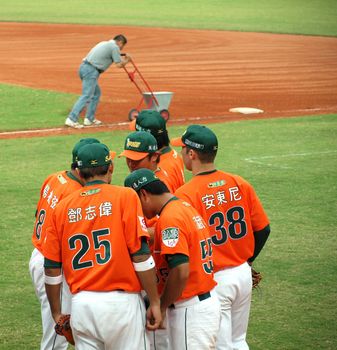 PINGTUNG, TAIWAN, APRIL 8: President Lions players who face the Lamigo Monkeys in a Pro Baseball League game discuss their strategy. The Lions won 2:0 on April 8, 2012 in Pingtung.