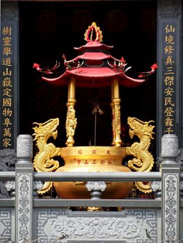 KAOHSIUNG, TAIWAN -- OCTOBER 13, 2013: This elaborate bronze cauldron that is used as an incense burner is located in the Tian Fu Temple in Kaohsiung City.