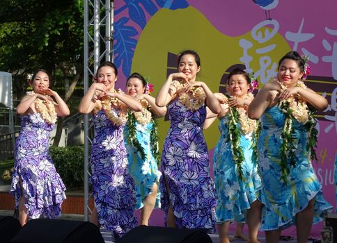 KAOHSIUNG, TAIWAN -- APRIL 23, 2016: A group of unidentified dancers performs a Hawaiian dance at the 1st Pacific Rim Ukulele Festival, a free outdoor event.