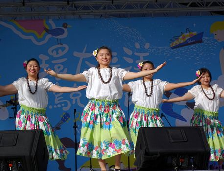 KAOHSIUNG, TAIWAN -- APRIL 23, 2016: A group of unidentified dancers performs a Hawaiian dance at the 1st Pacific Rim Ukulele Festival, a free outdoor event.