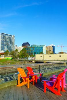 View of harbor and downtown buildings, with colorful chairs, in Halifax, Nova Scotia, Canada