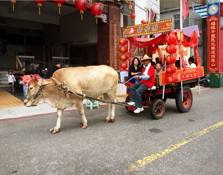 KAOHSIUNG, TAIWAN -- OCTOBER 13: A traditional Taiwanese ox cart is a special attraction at the yearly Wannian Folklore Festival on October 13, 2013 in Kaohsiung.