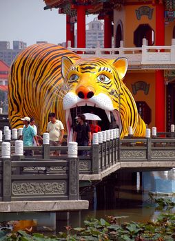 KAOHSIUNG, TAIWAN -- OCTOBER 13: Visitors emerge from the famous Tiger Pagoda at the yearly Wannian Folklore Festival on October 13, 2013 in Kaohsiung.