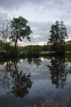 The Orne river and nearby fields, near the villages of Clecy and Le Vey, in Normandy, France. This region is known as Swiss Normandy