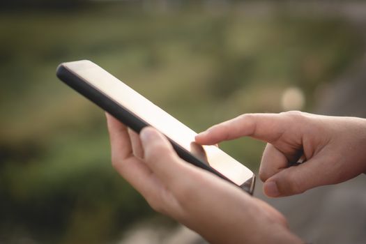 Woman hand use smartphone to do work business, social network, communication in public space.