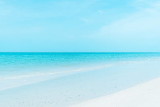 Tropical nature clean beach and white sand in summer with sun light blue sky and bokeh abstract  background.