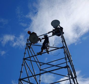 KAOHSIUNG, TAIWAN -- MAY 21, 2017: Workers set up powerful lights on scaffolds in preparation for the upcoming Dragon Boat Festival.
