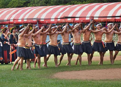 KAOHSIUNG, TAIWAN -- SEPTEMBER 28, 2019: Young men of the indigenous Rukai tribe perform a dance during the traditional harvest festival.