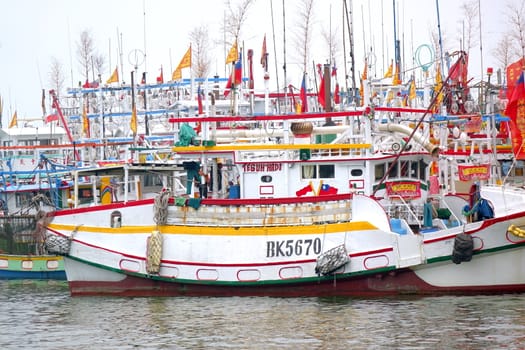 LINYUAN, TAIWAN -- MAY 28, 2017: A large flotilla of fishing vessels is anchored in the Zhongyun Fishing Port.