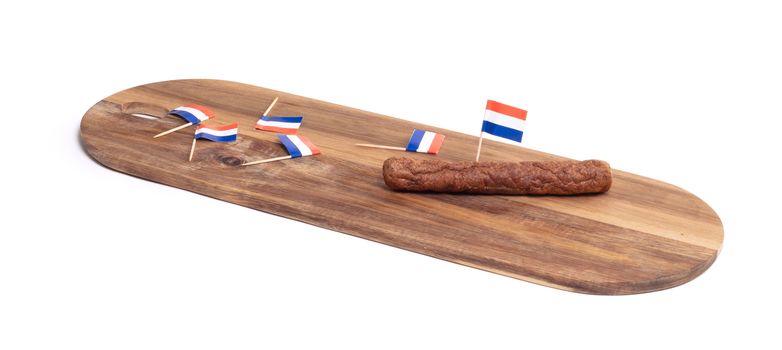 Wooden tray with just one frikadel left, a Dutch fast food snack, isolated