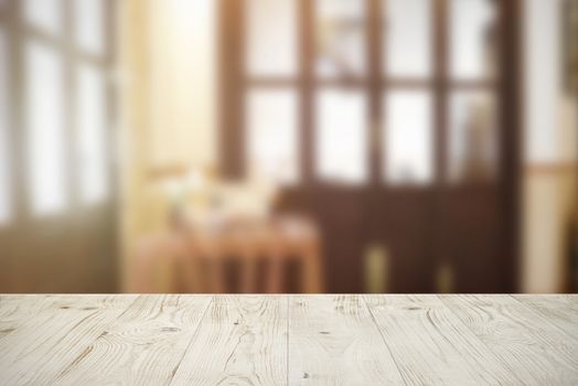 Empty wooden board table top on blur abstract of cafe or restaurant background, for montage product or display, mock up for display of product