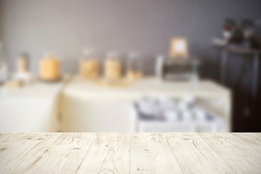 Empty wooden board table top on blur abstract of restaurant or catering background, for montage product or display, mock up for display of product