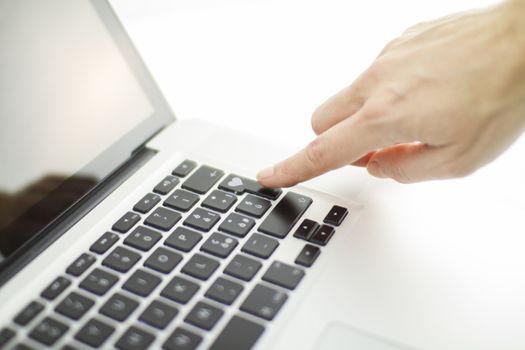 Technology also applies to emotional relationships: a woman's hand is about to press a key on a laptop keyboard with a stamped heart