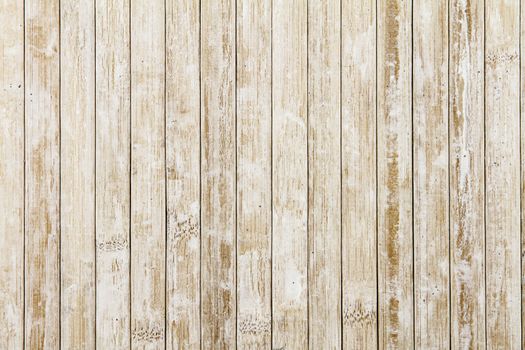 Light wooden background composed of vertical wooden planks ruined by time