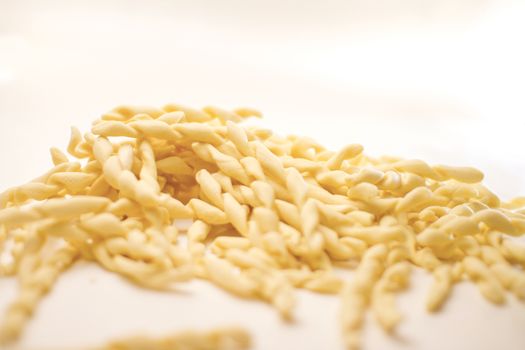 Close up still life of italian handmade pasta fusilli al ferretto on white background