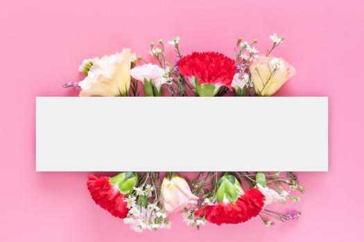 creative layout made with fresh colorful spring flowers on bright pink background with white rectangle bar banner label. wedding invitation, posters or greeting design