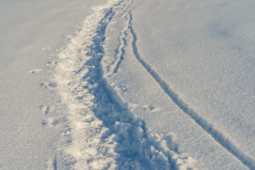 Path in a snowy field, rural winter landscape