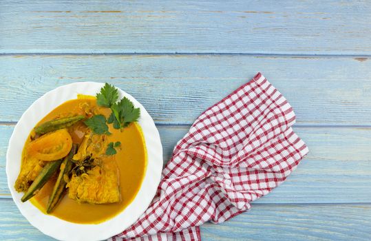 Spicy and tasty fish curry dish, Traditional Malaysian cuisine. Selective focus.