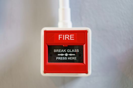 Red fire alarm box on white background.
