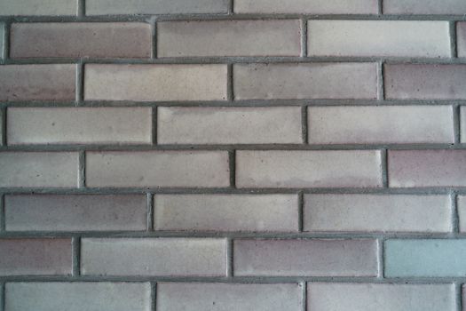Grey brick tiled wall texture background.