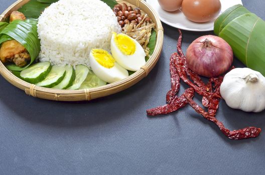 Nasi Lemak is a commonly found food in Malaysia, Brunei and Singapore. It is also an unofficial national food in Malaysia. Selective focus.