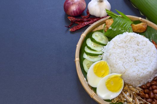 Nasi Lemak is a commonly found food in Malaysia, Brunei and Singapore. It is also an unofficial national food in Malaysia. Selective focus.