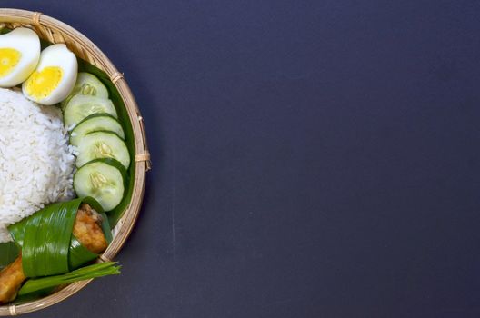 Nasi Lemak is a commonly found food in Malaysia, Brunei and Singapore. It is also an unofficial national food in Malaysia. Selective focus.