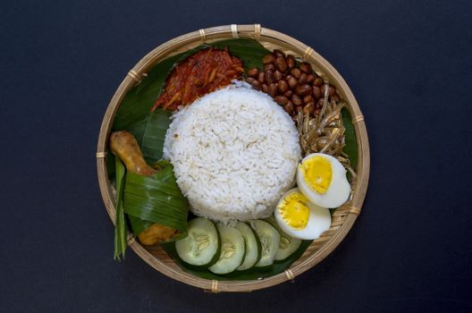 Nasi Lemak is a commonly found food in Malaysia, Brunei and Singapore. It is also an unofficial national food in Malaysia. Selective focus.