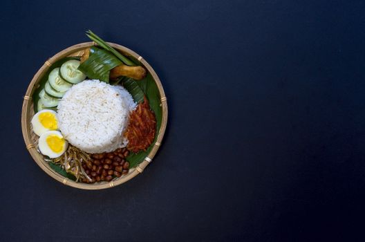 Nasi Lemak is a commonly found food in Malaysia, Brunei and Singapore. It is also an unofficial national food in Malaysia. Selective focus.