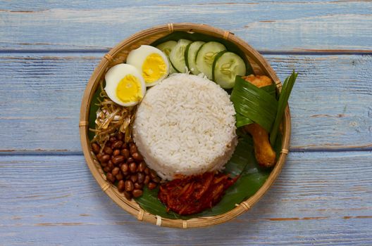 Nasi Lemak is a commonly found food in Malaysia, Brunei and Singapore. It is also an unofficial national food in Malaysia. Selective focus.