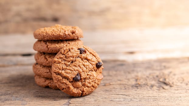 stack of chocolate chip cookies on wooden table