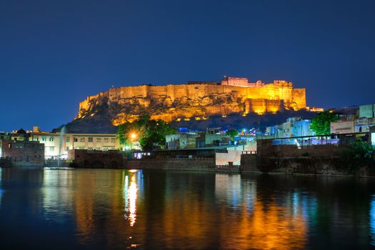 Famous indian tourist landmark Mehrangarh fort in the evening view over Gulab Sagar lake. Jodhpur, Rajasthan, India